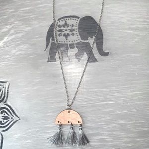 A Handmade Necklace with a Wood Tassel Pendant